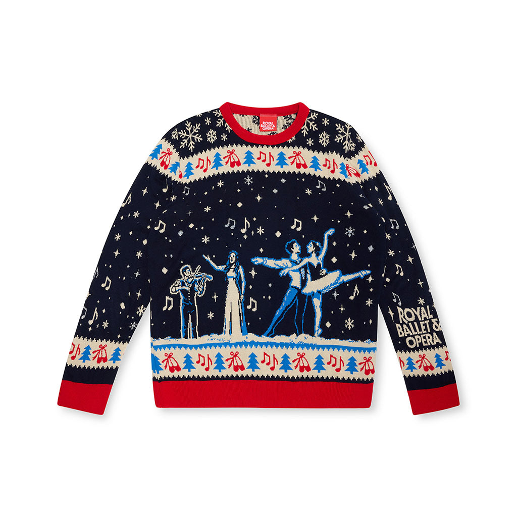A navy blue long-sleeve crewneck sweater featuring a festive Christmas ballet theme. The design includes a red crew neck and cuffs, a red and blue patterned horizontal band across the chest and lower body, white snowflakes and musical notes, and illustrations of ballet dancers, a singer and violinist.