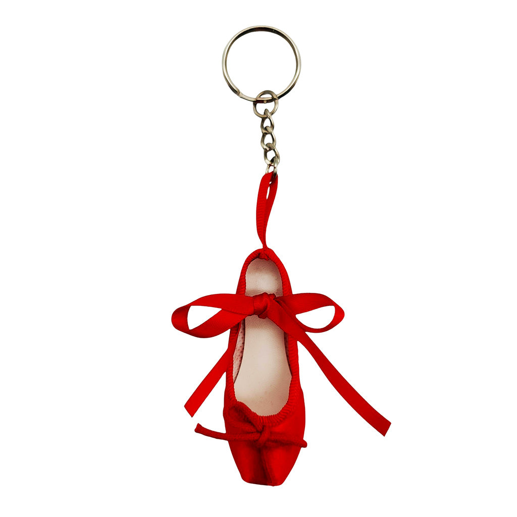 Red ballet shoe keyring with a bow on a white background