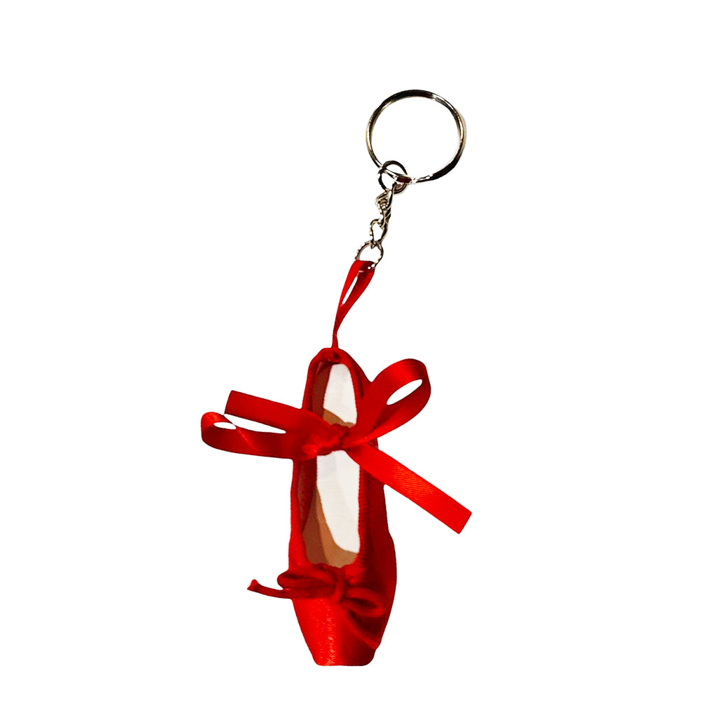 Red ballet shoe keychain with a ribbon on a white background