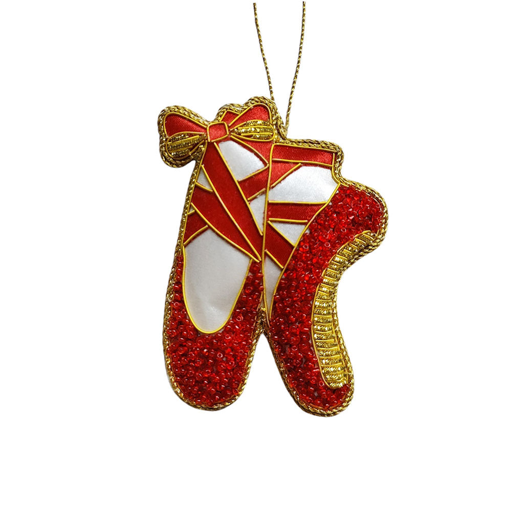 A red  and gold beaded ballet pointe shoe decoration on a white background
