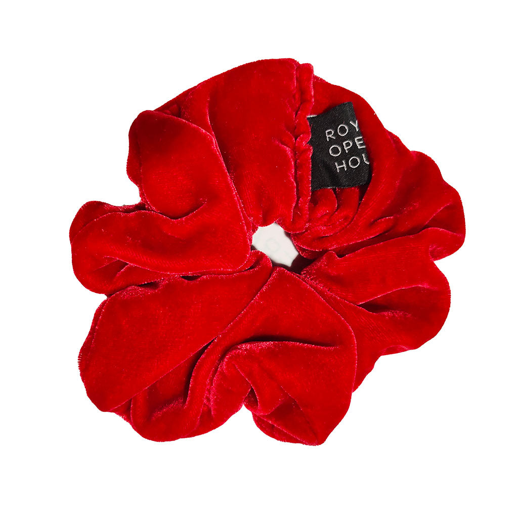 Red velvet scrunchie with a brand tag on a white background