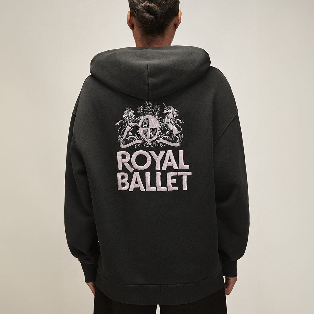 back view of a Black hoodie with a logo the Royal Ballet crest embroidered on the back