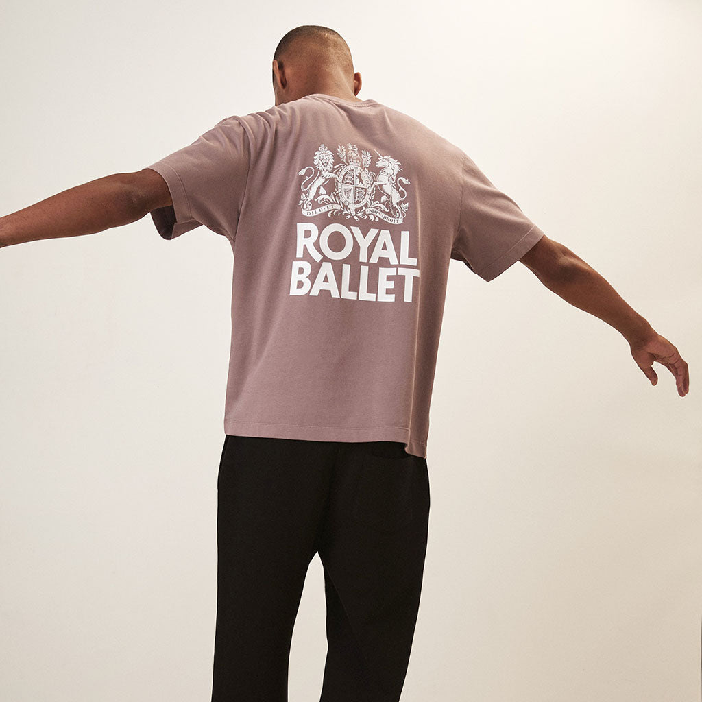 Back view of the t-shirt on a man with a big white printed Royal Ballet crest on the cenre back
