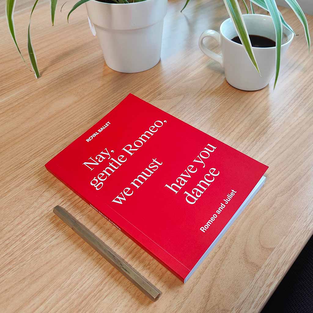 Romeo and Juliet Notebook on table with plant and  cup of coffee
