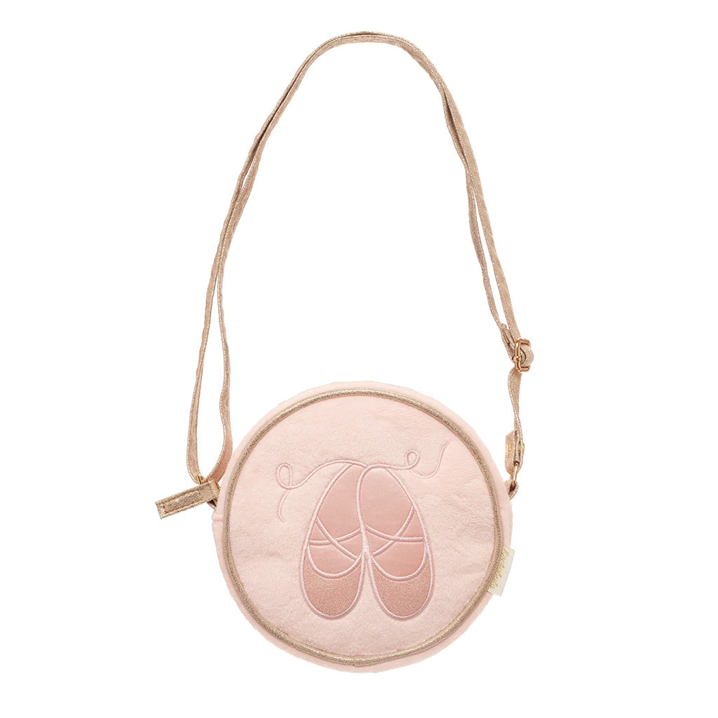 A round, childrens light pink fabric crossbody bag featuring an embroidered ballet shoe design in the centre, complete with a matching adjustable shoulder strap and a small gold-toned zipper pull.