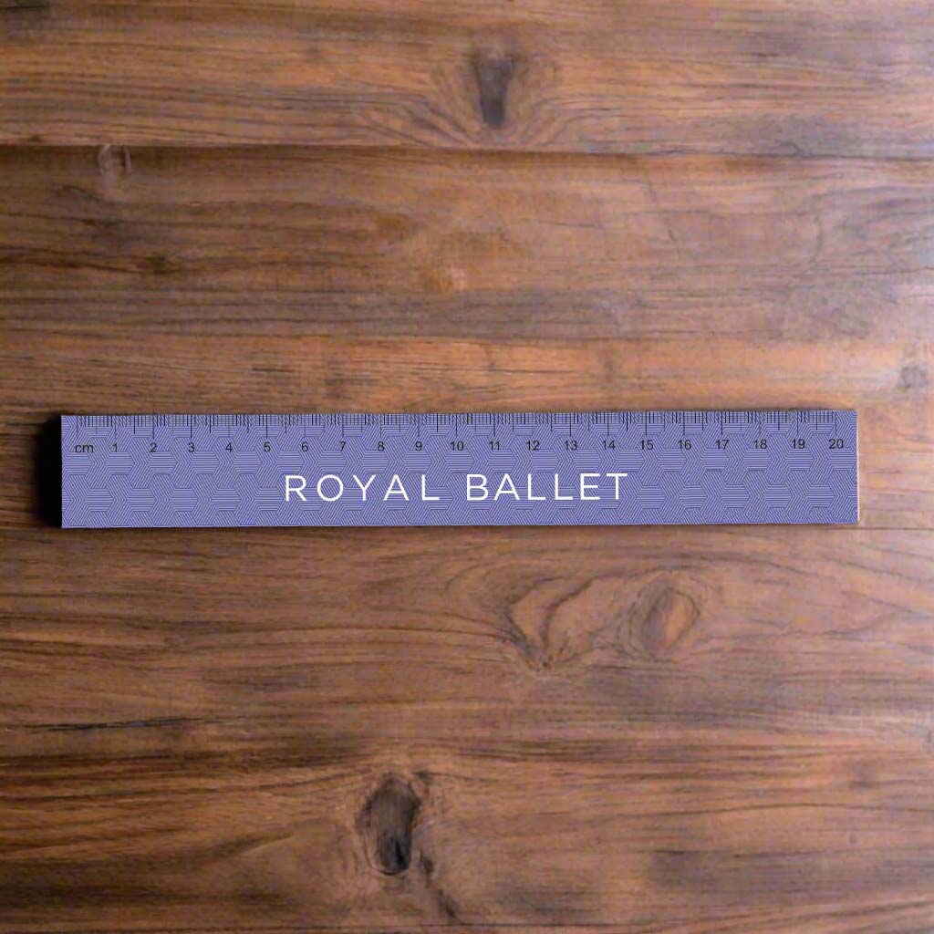 Purple bamboo ruler with &#39;Royal Ballet&#39; text on a wooden surface