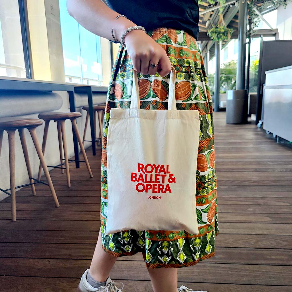 Small cream tote bag with 'Royal Ballet & Opera London' text in red on a white background