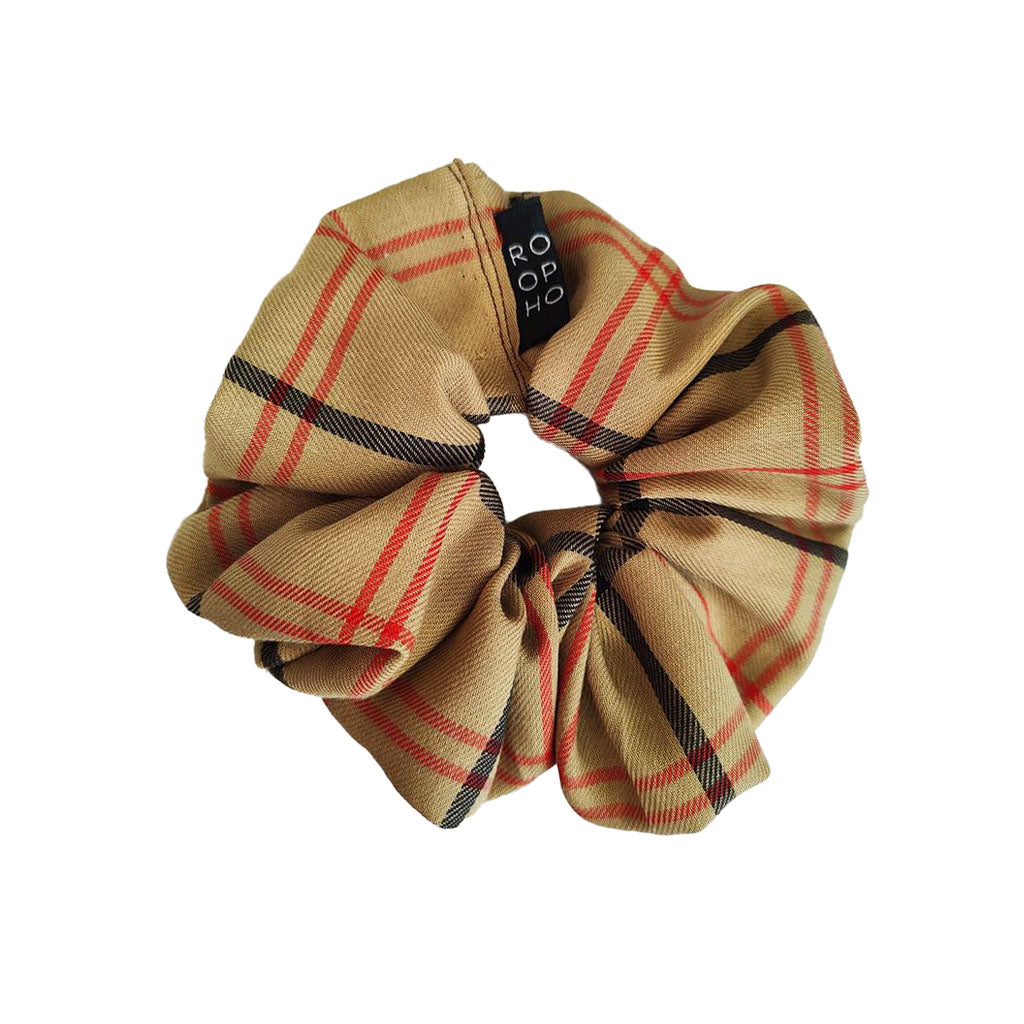 Plaid patterned Opera scrunchie with an ROH brand label on a white background