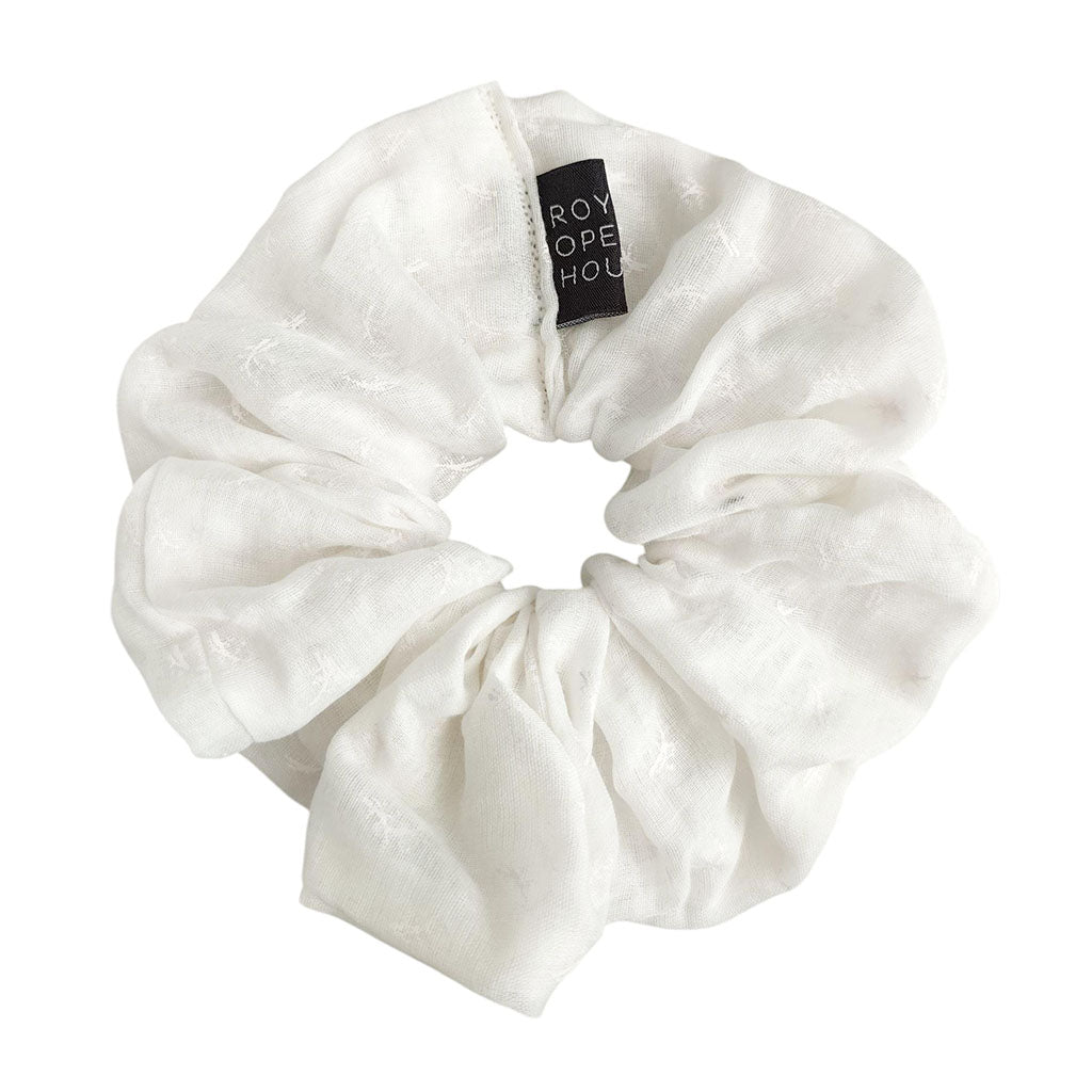White scrunchie with an roh tag on a white background