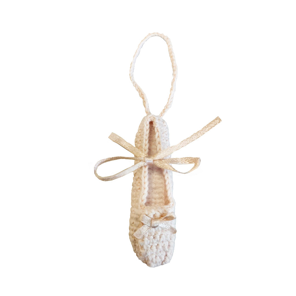 miniature crocheted ballet pointe shoe decoration on a white background