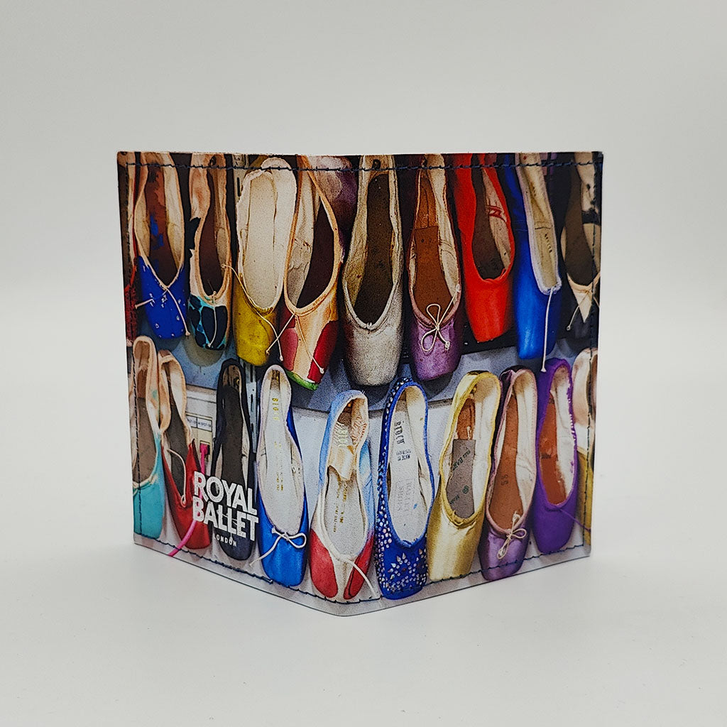 back view of cardholder with colourful ballet pointe shoe design on a gray background