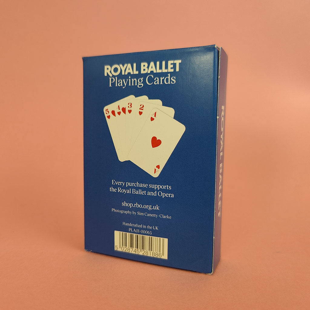 The blue packaging box for Royal Ballet Playing Cards, showing the back with the product name, a graphic of playing cards, and a barcode, set against a solid peach background.