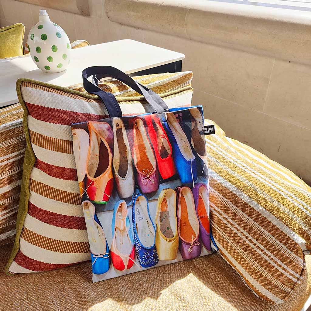 Tote bag with colourful ballet shoes design on a couch