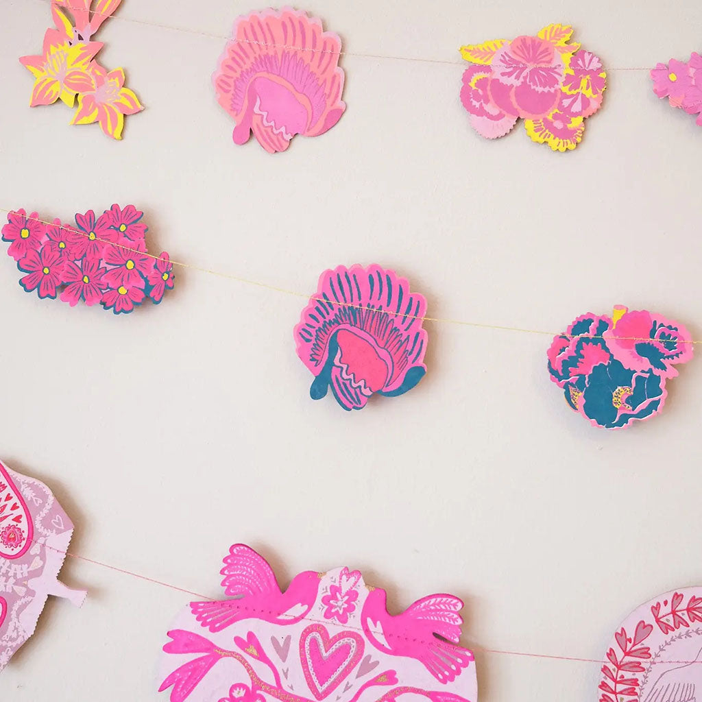 Decorative garland with pink floral designs on a white background