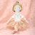 Sugar Plum Fairy Doll with a white dress and lace skirt on a white background