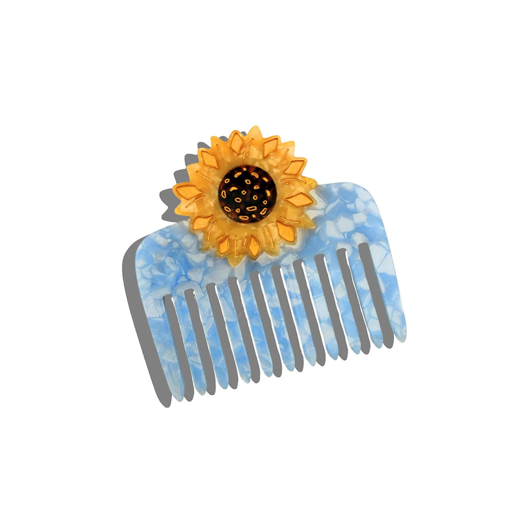blue and white resin comb with a  yellow sunflower on top
