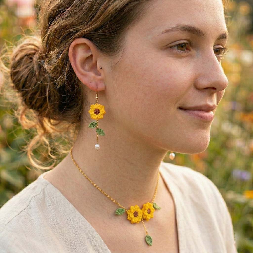 model wearing the crochet sunflower necklace outside with green background