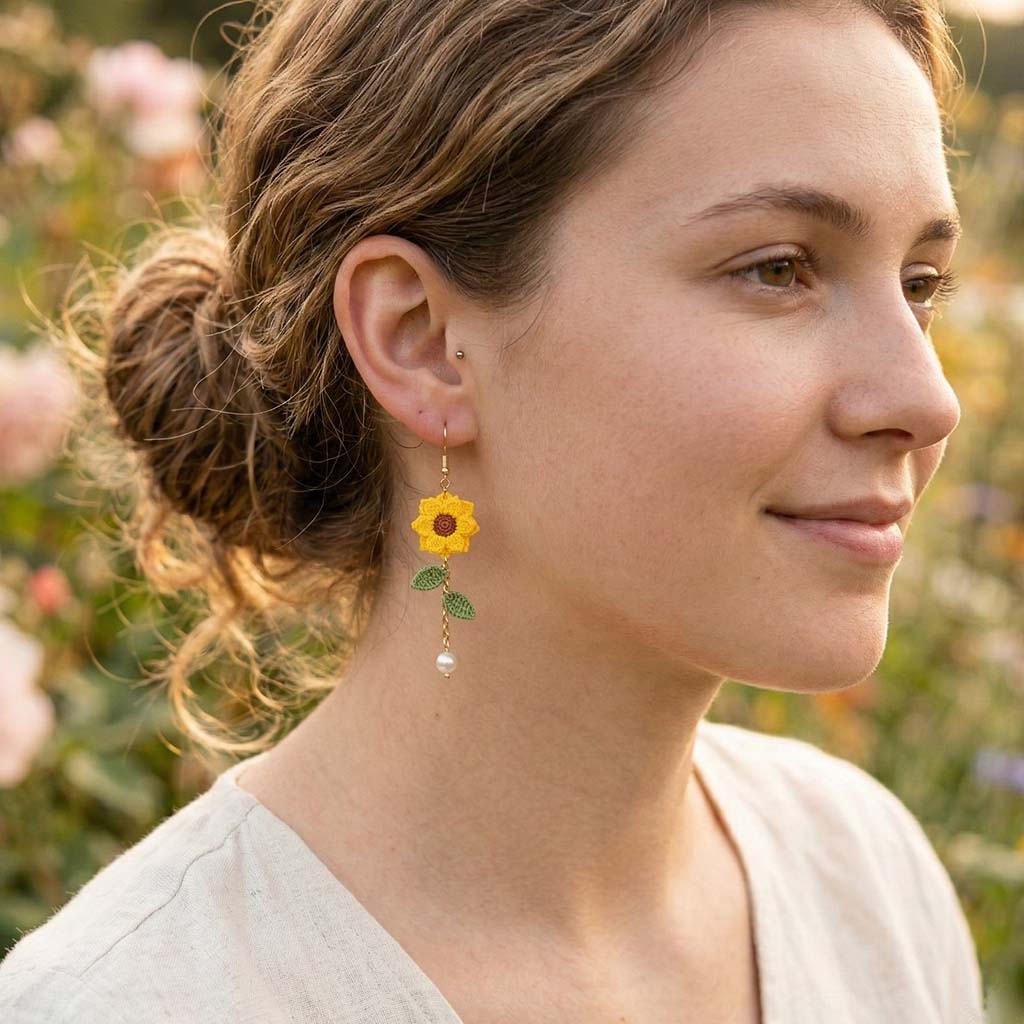 model wearing sunflower earrings outside in a garden
