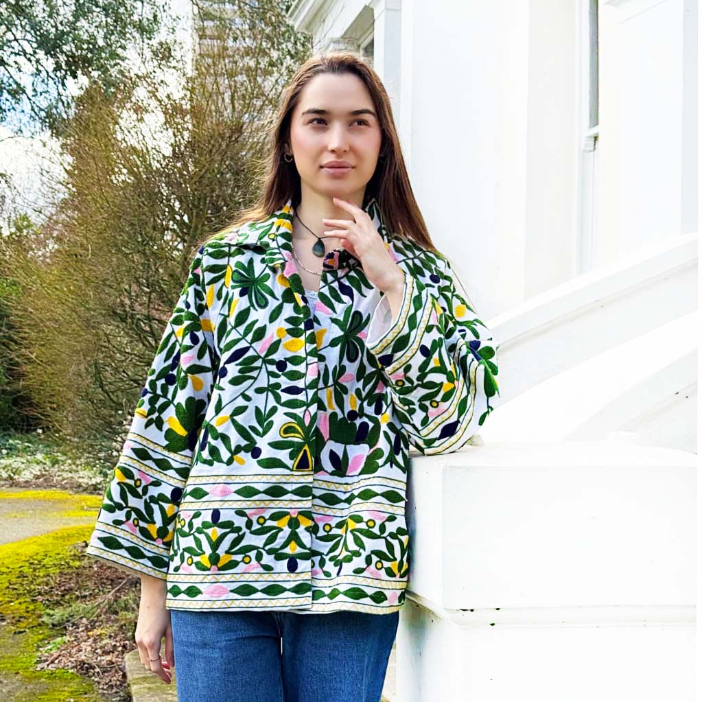 Woman wearing a colourful embroidered jacket outdoors