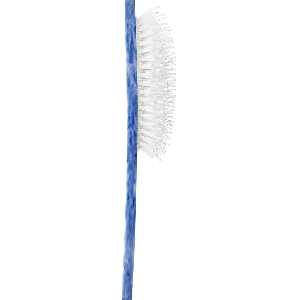 A close-up of a  hair brush with a blue marbled handle and white bristles, shown vertically on a plain white background.