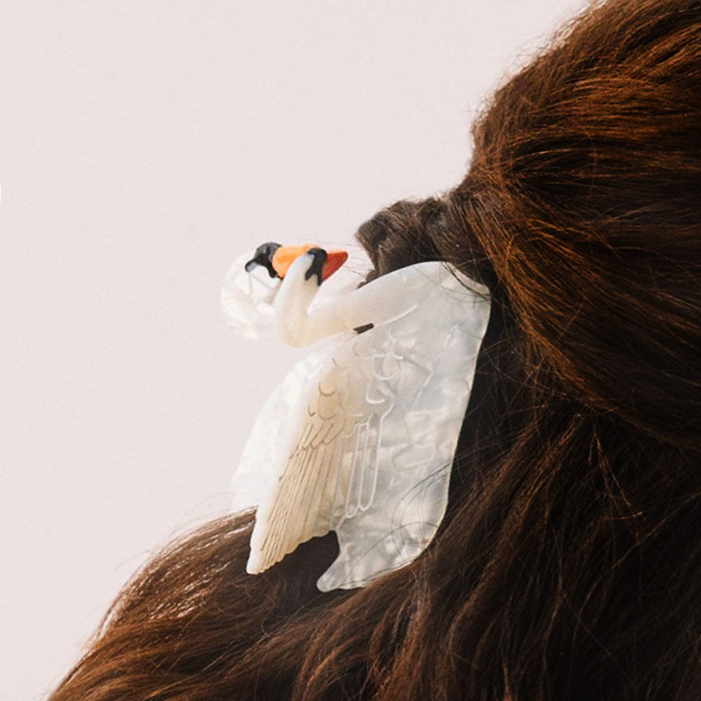 Decorative swan hair clip on a white background