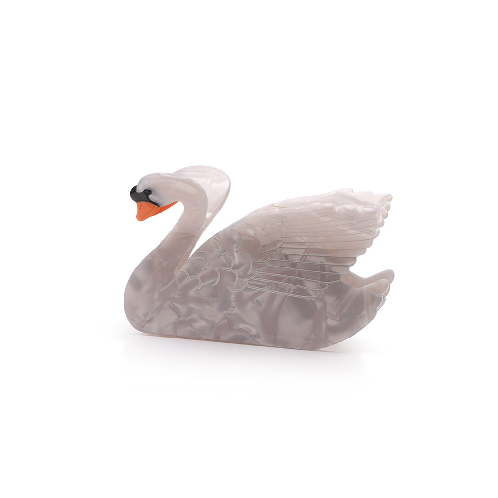 Decorative swan hair clip on a white background
