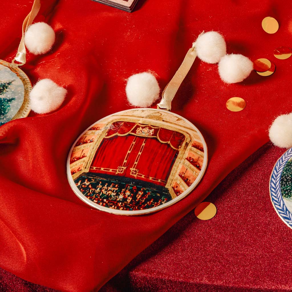 Auditorium Tin Decoration on red velvet with pom poms