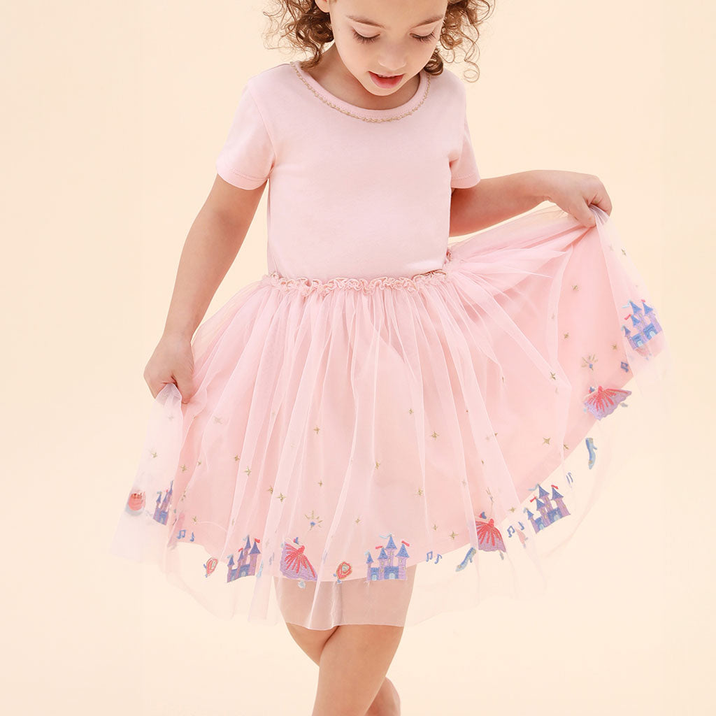 child in fairy tale embroidered tutu dress with cream background