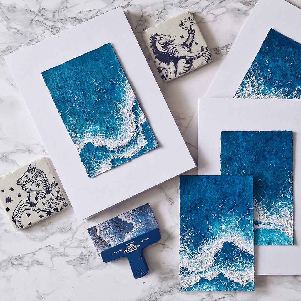 The Waves textured art piece in blue and white mounted on an A4 white board