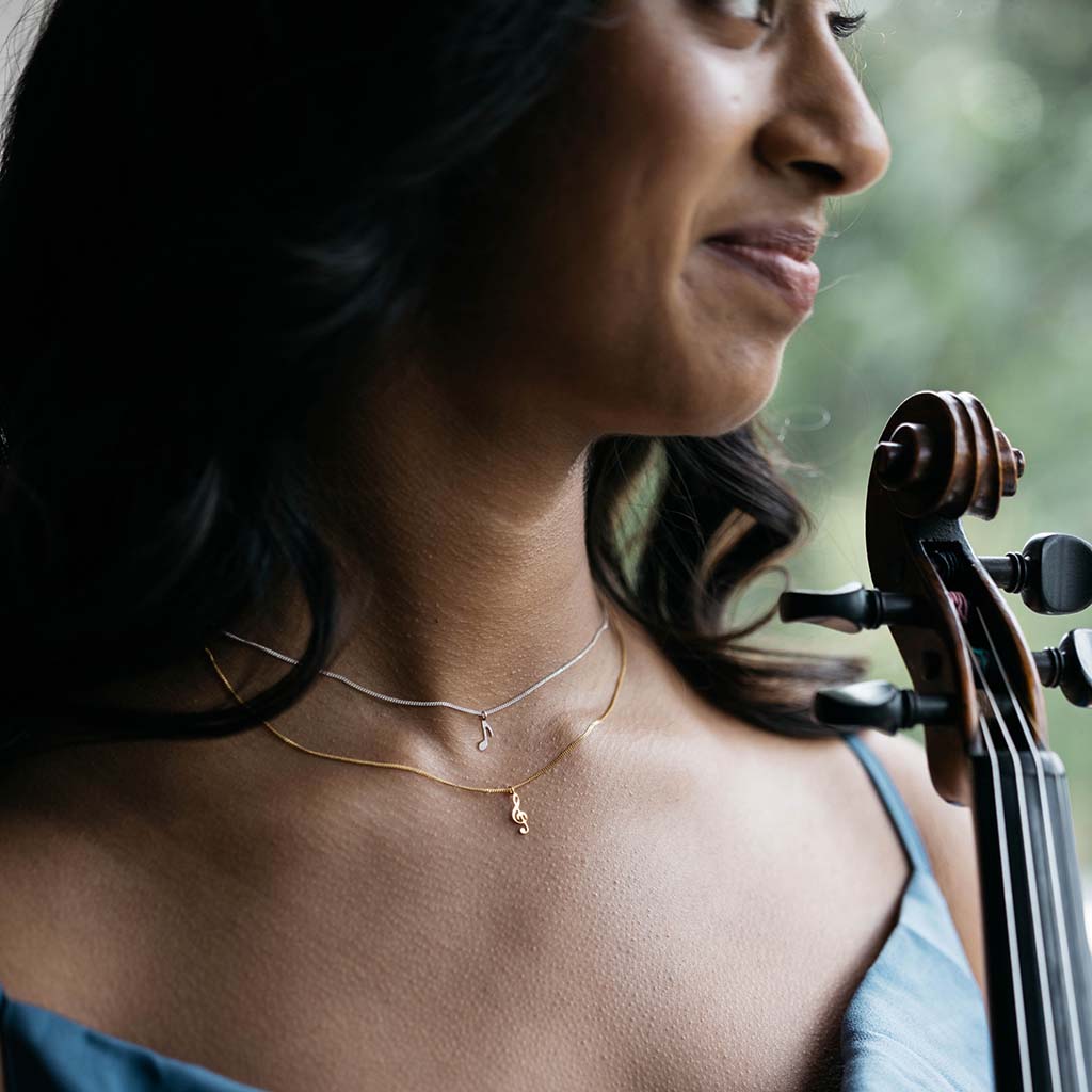 Treble Clef and quaver pendant necklaces on violinist
