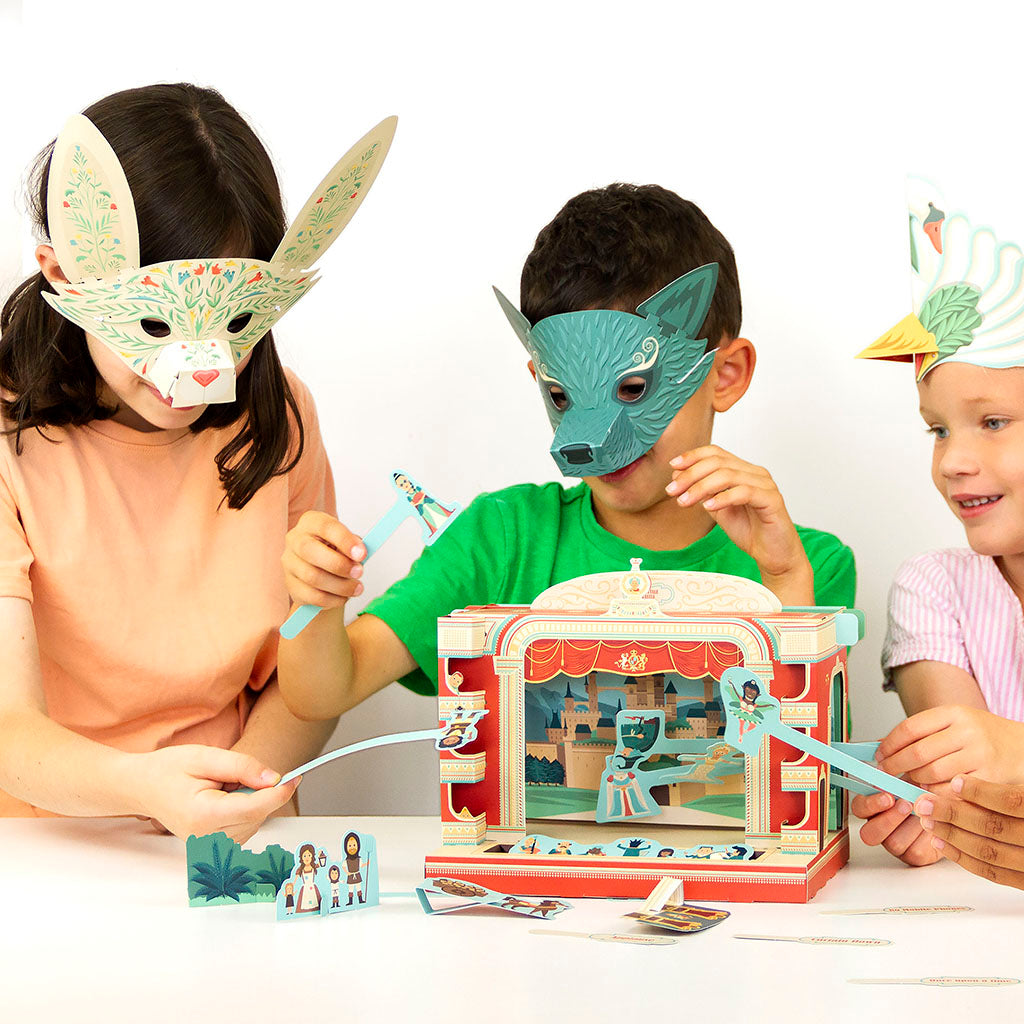 Card puppet theatre inspired by the RBO with colourful stage and characters, held by a hand.