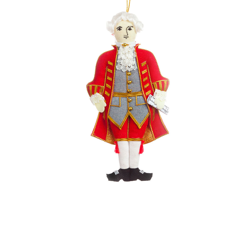  decoration featuring Mozart in a red tail coat with gold detail holding a music score, on a white background